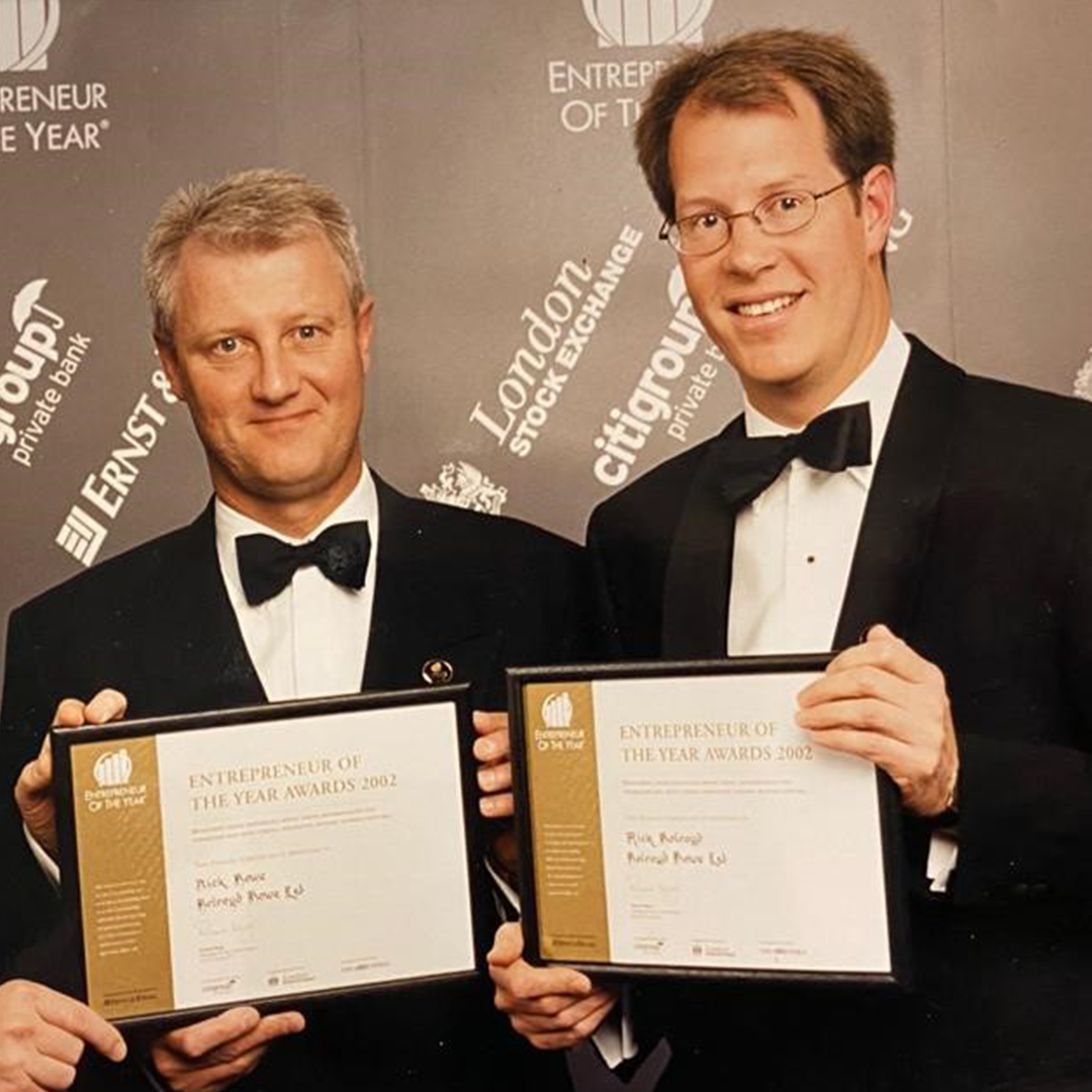 An image of the two co-founders folding certificates for the entrepreneur awards