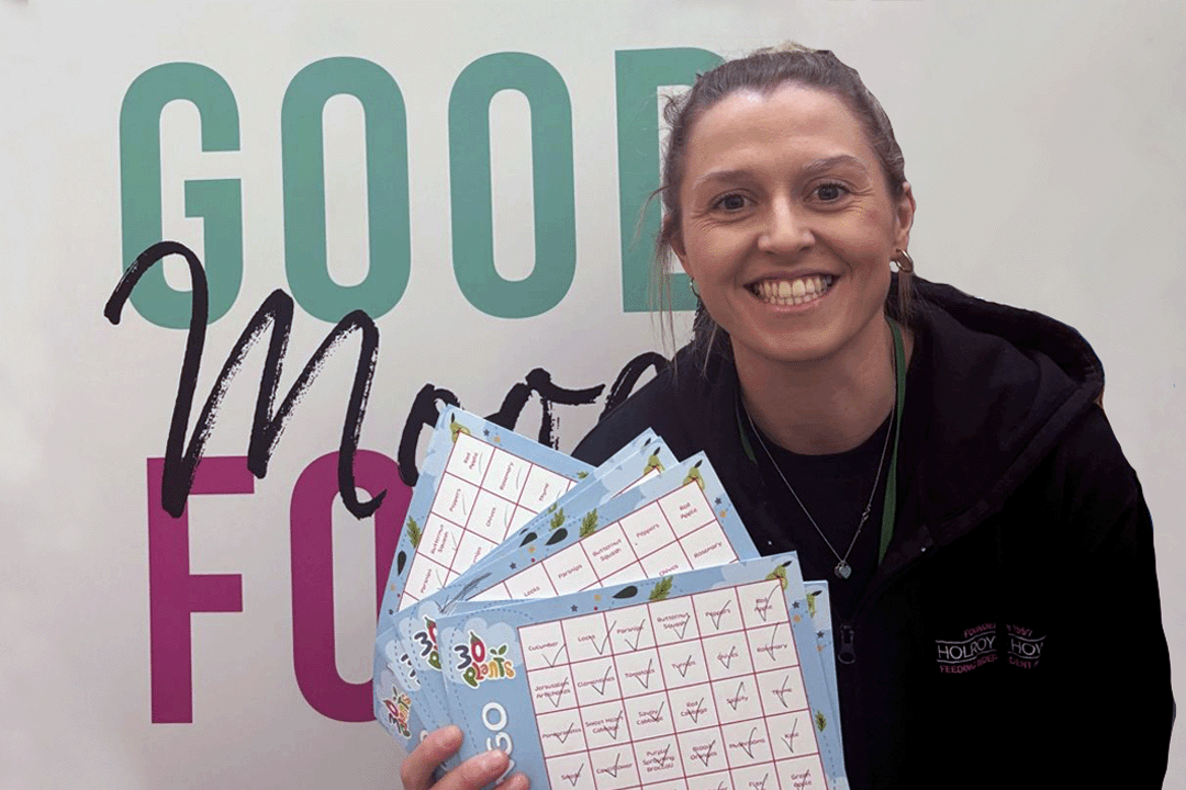 Nutrician. An image of a person holding up a game of a healthy eating bingo card