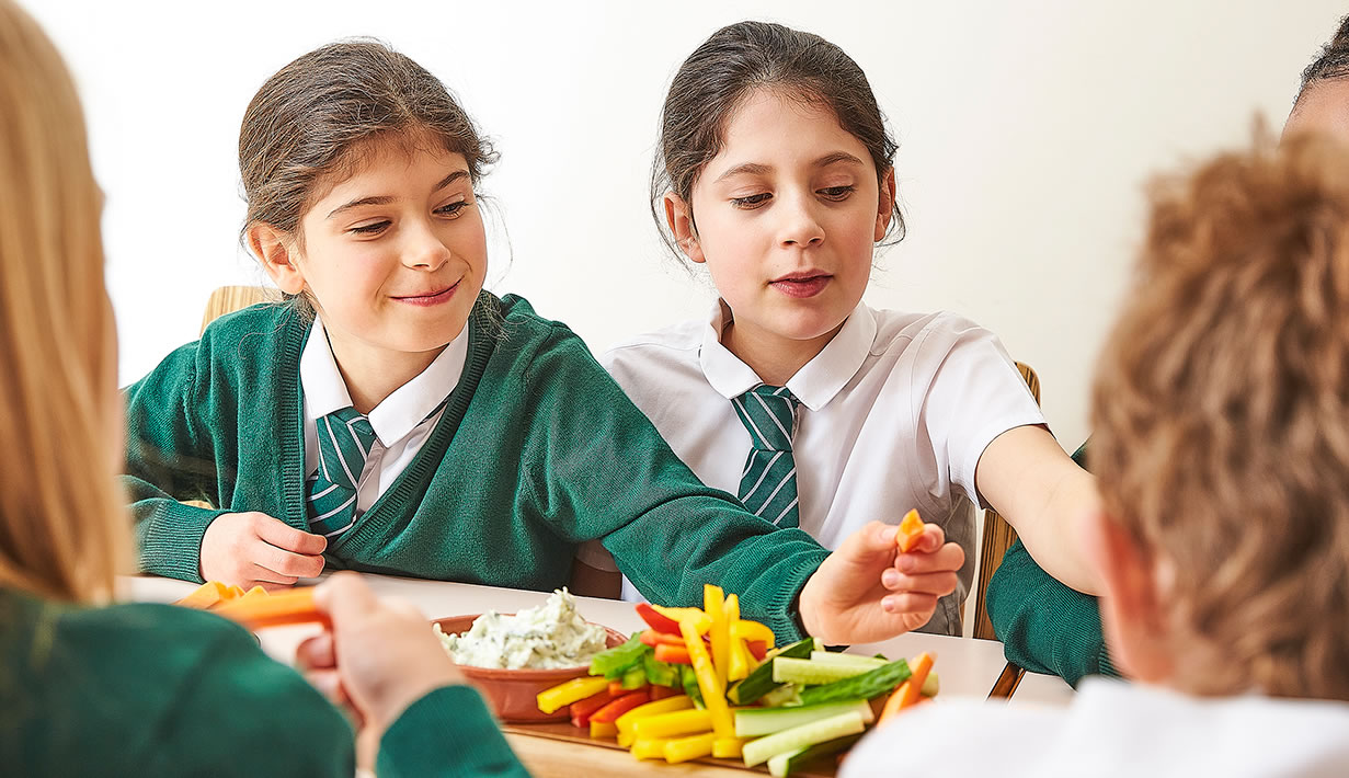 An image of two pupils sharing a platter of crudites
