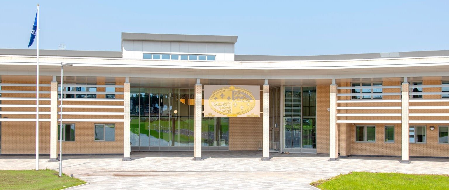 A modern, single-story building with large glass windows and a flat roof.