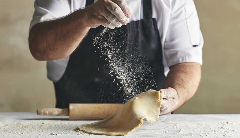 Bespoke catering services. An image of a chef making pastry