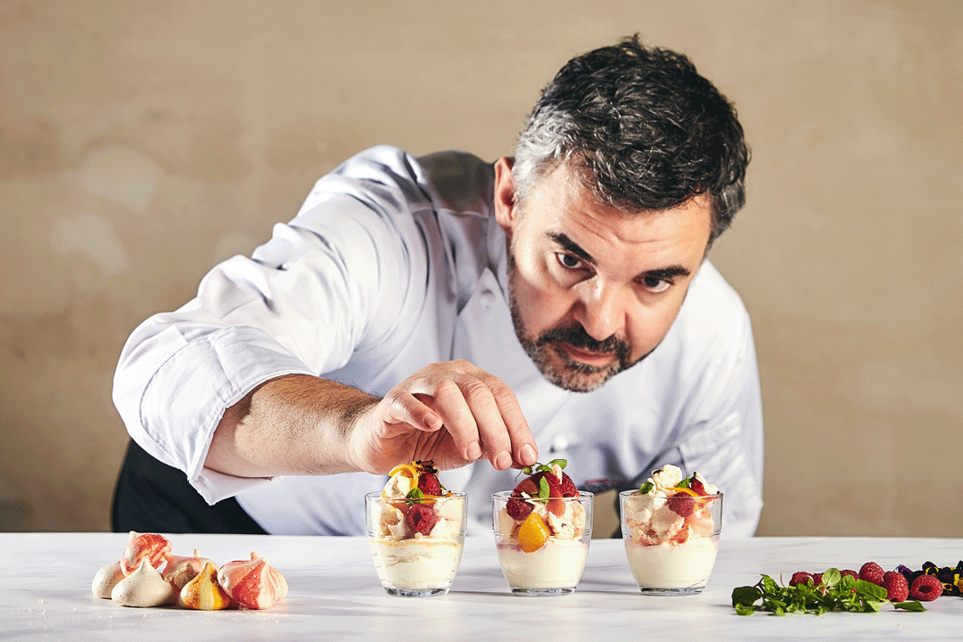 Bespoke catering services. An image of a chef topping some fine dining desserts