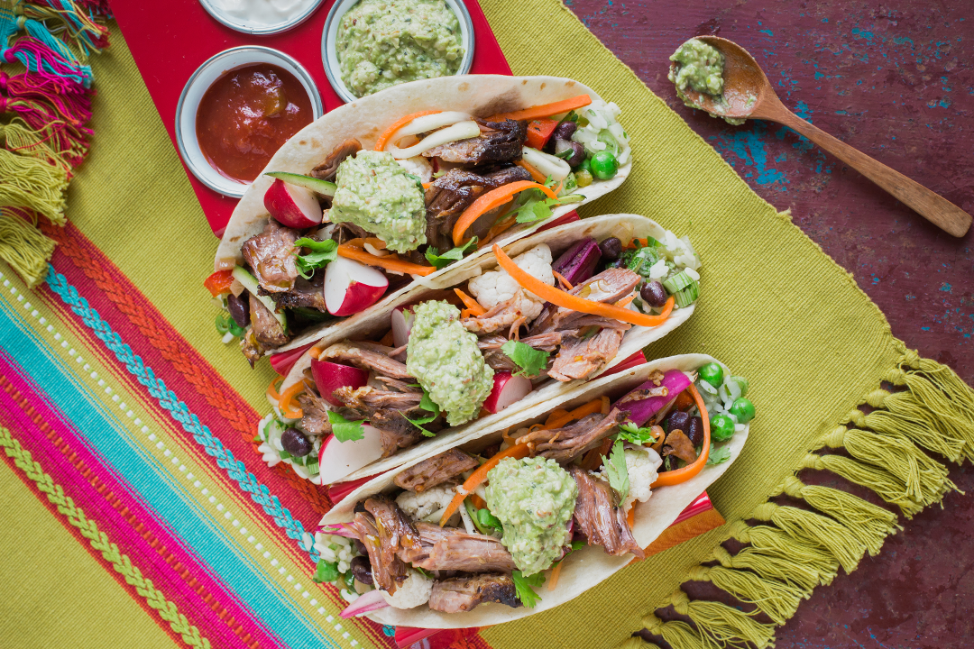 School dining. Image of a Mexican Food Innovation concept dish of pulled lamb tacos with selected dips