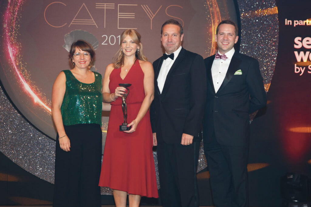Healthy eating champion. An image of a group of people at the cateys award ceremony. One individual holds a trophy.