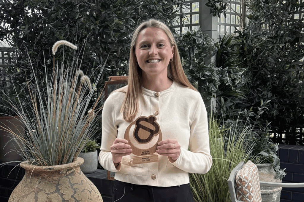 Ellie Olds. Holroyd Howe's nutritionist holding a 30 under 30 acorn award