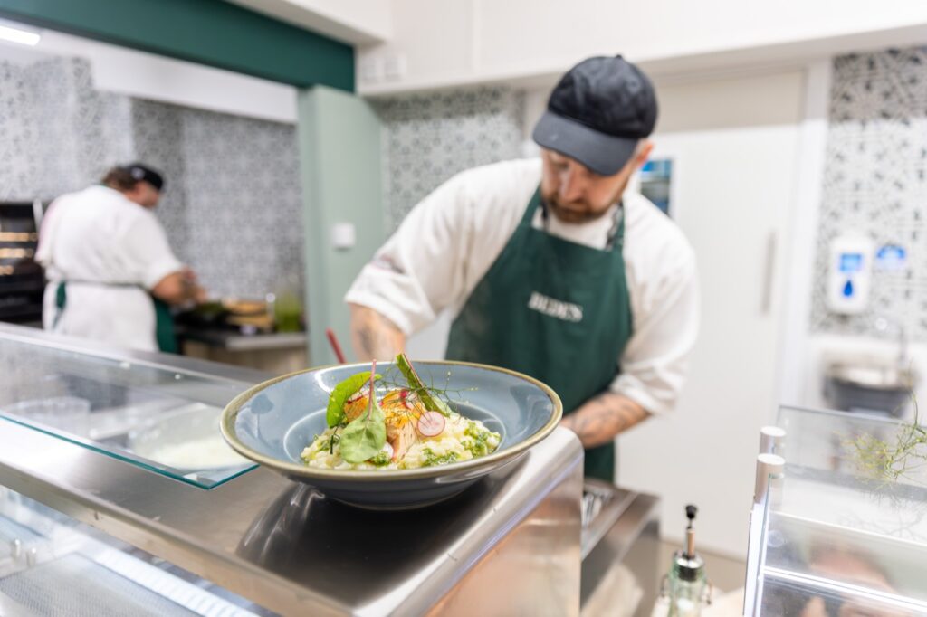 Home 35 Holroyd Howe chef plating a fresh salad bowl